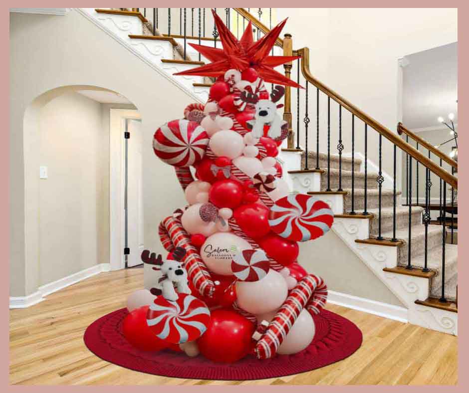 Christmas Balloon tree decoration. In red and white decorated with peppermint candy and cane  balloons, standing next to a staircase. Oregon Balloon Decor Christmas