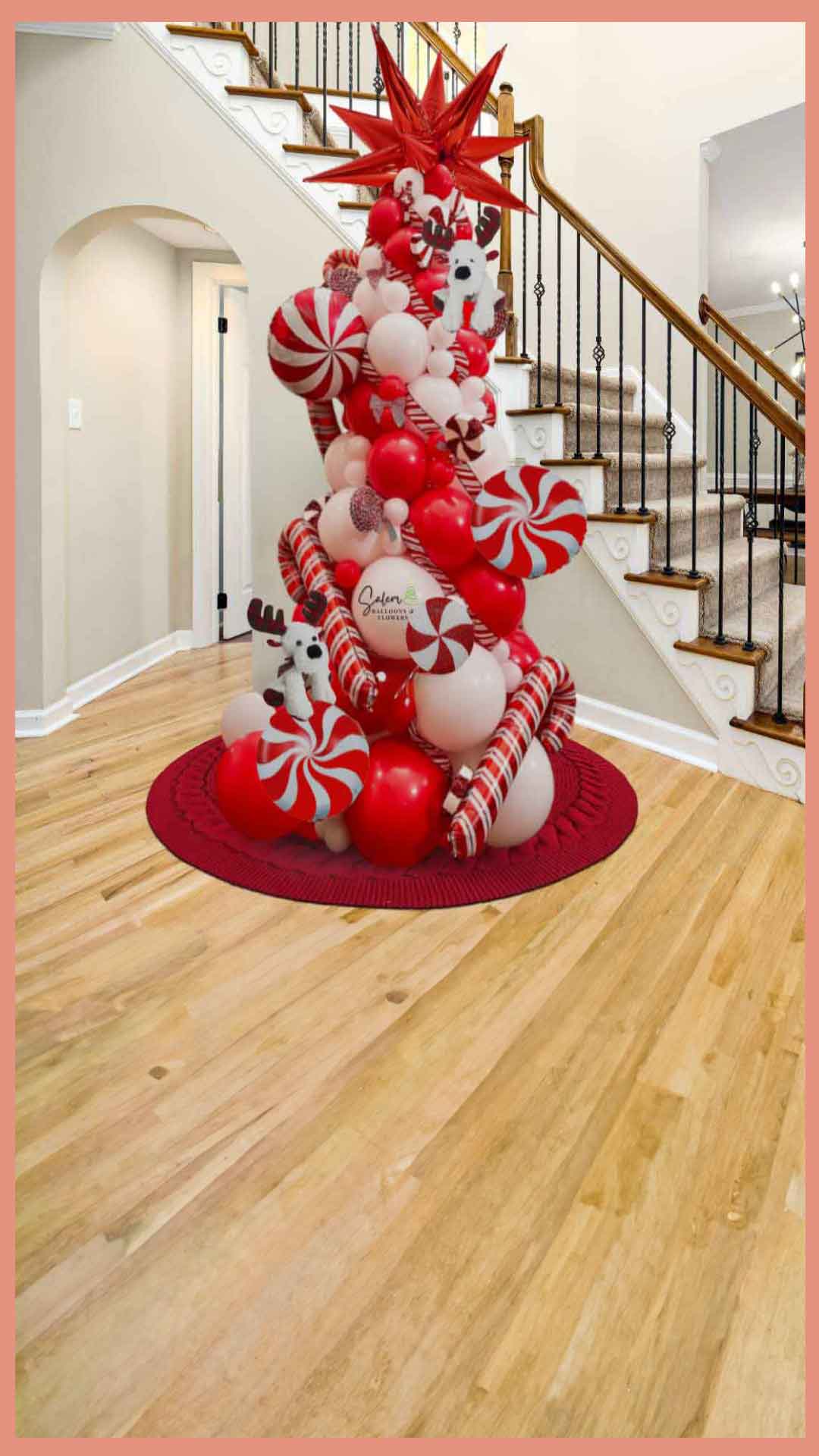 Christmas Balloon tree decoration. In red and white decorated with peppermint candy and cane  balloons, standing next to a staircase. Oregon Balloon Decor.  Christmas balloon columns. 