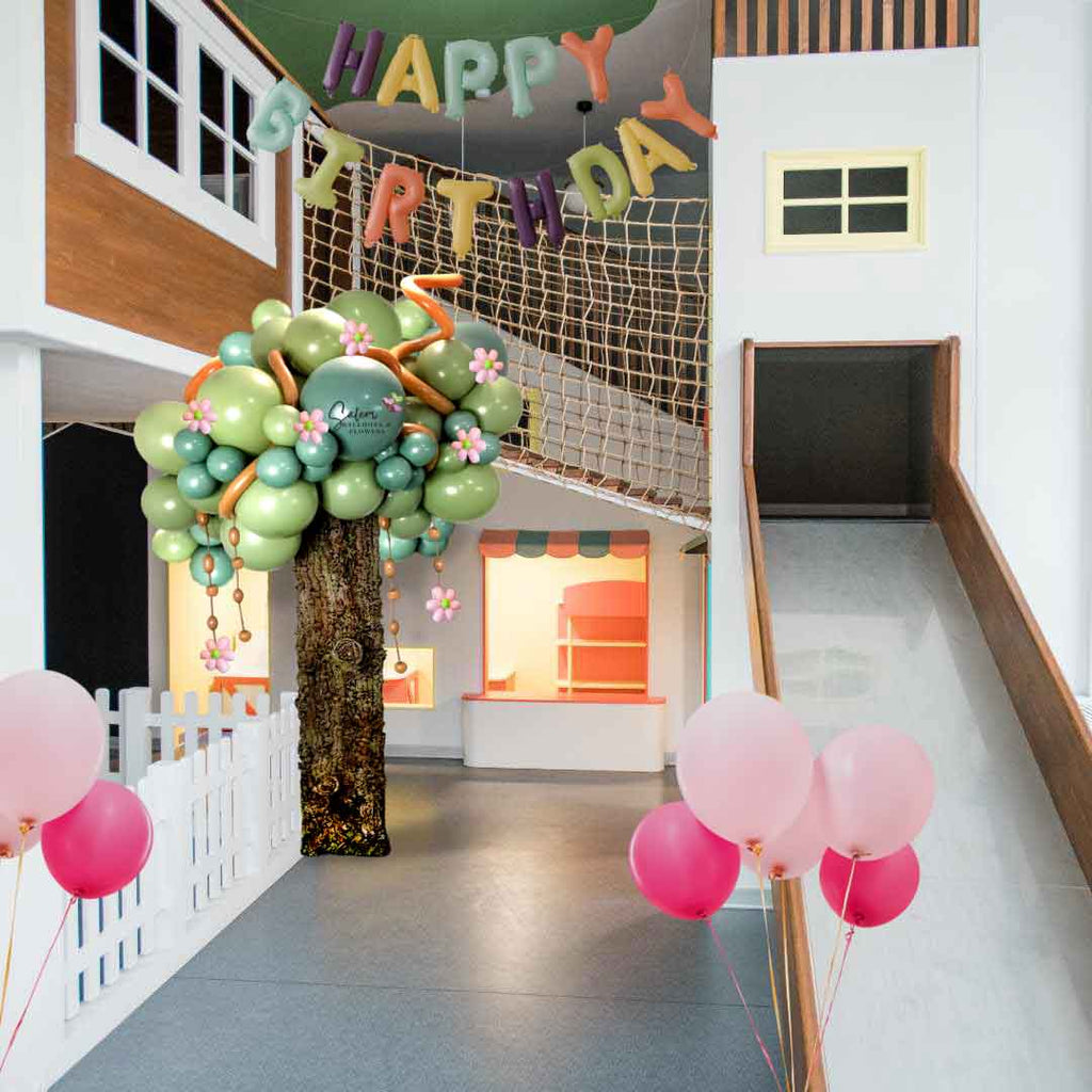 A balloon tree column decorating a playground with helium balloons and a Happy Birthday Balloon Banner. Oregon Balloon decor. Salem Oregon and nearby cities.