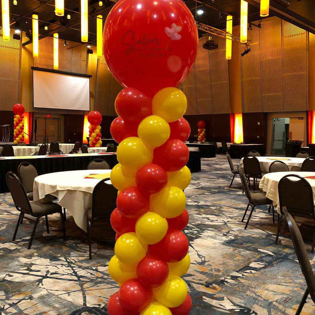 8 ft balloon columns in red and yellow standing in Salem Convention Center. Oregon Balloon Decor