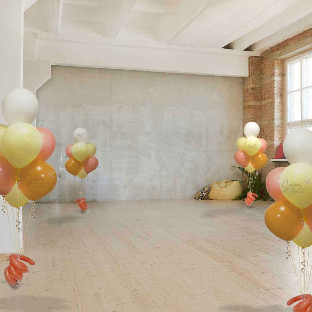 Dancing Ballroom decorated with 4 Balloon bouquet centerpieces made of 7 helium filled balloons in pastel orange and yellow.  Oregon Balloon Decor.