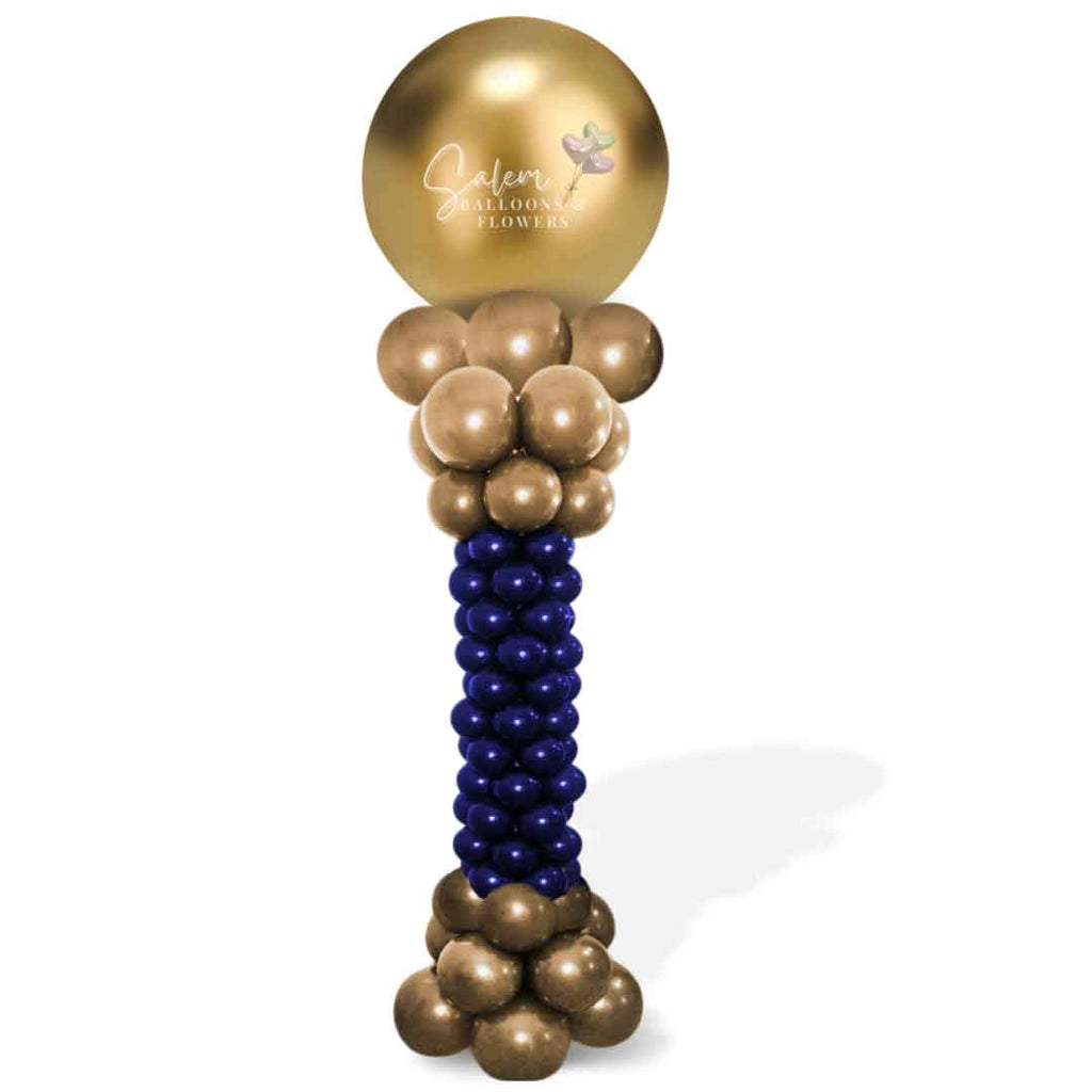 A balloon column with a curvy form and round topper in gold and blue. Oregon Balloon Decor