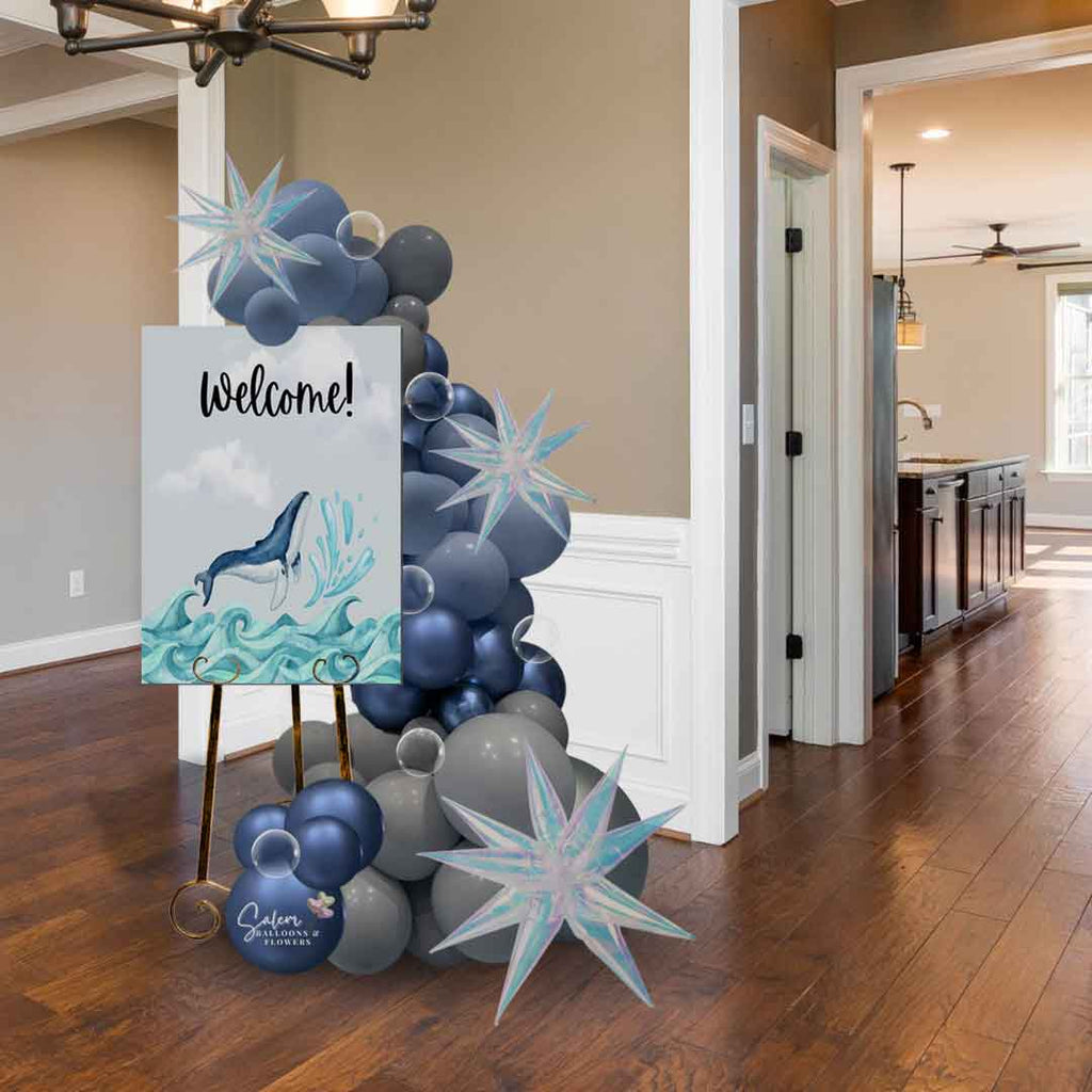 Hallway decorated with a Deluxe edition Organic Easel Balloon Garland in a gray and blue color palette.  Embellished with iridescent starburst balloons and Christal clear balloon bubbles. Available in willamette Oregon.