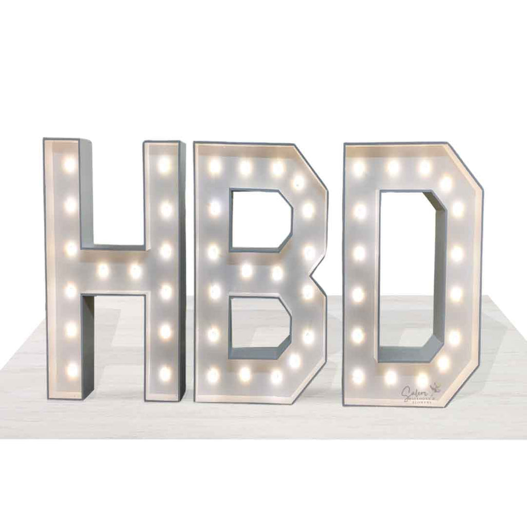 White light-up HBD marquee letters standing on a white floor. Salem Oregon Balloon decor