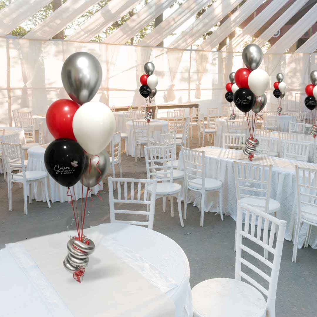 Venue with white tables and balloon centerpieces in silver, red, white and black. Salem Oregon balloon decor.