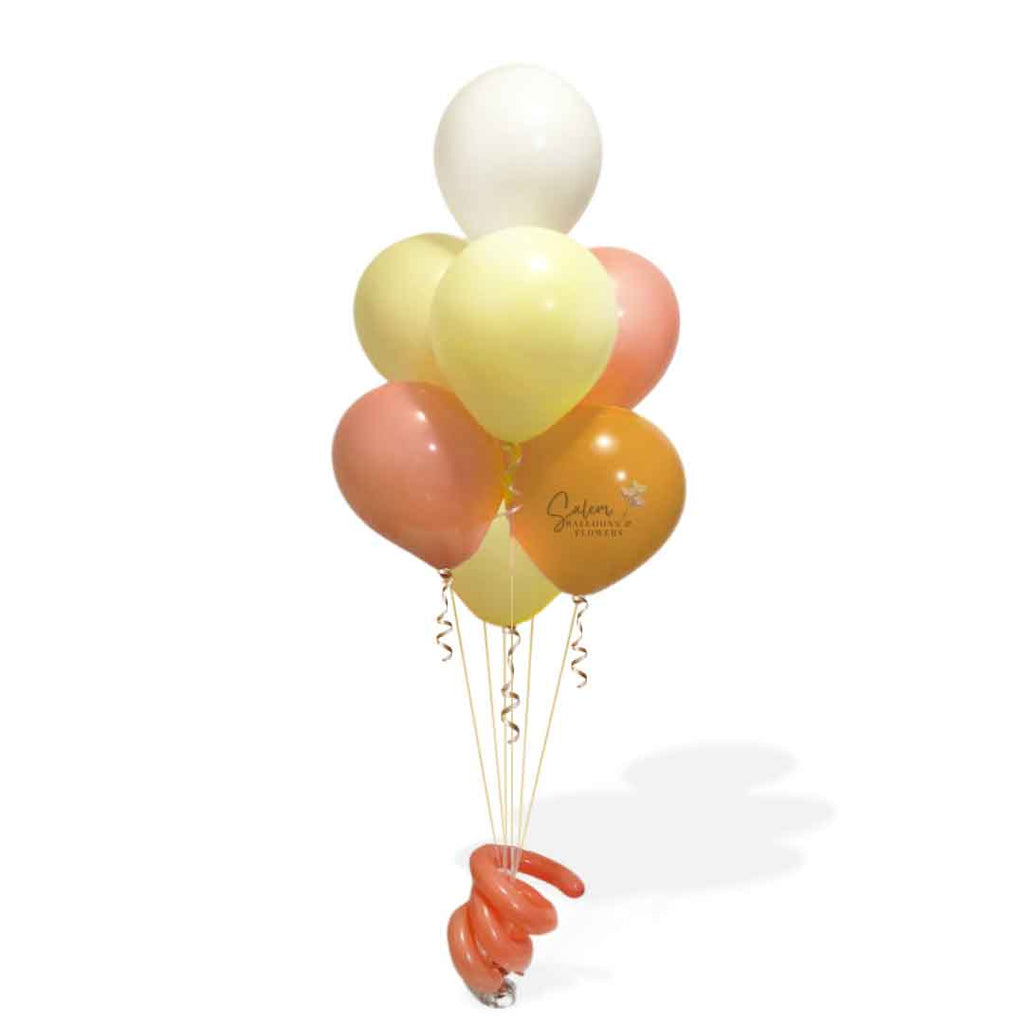 Balloon bouquet centerpiece made of 7 helium filled balloons in pastel orange and yellow.  Oregon Balloon Decor.