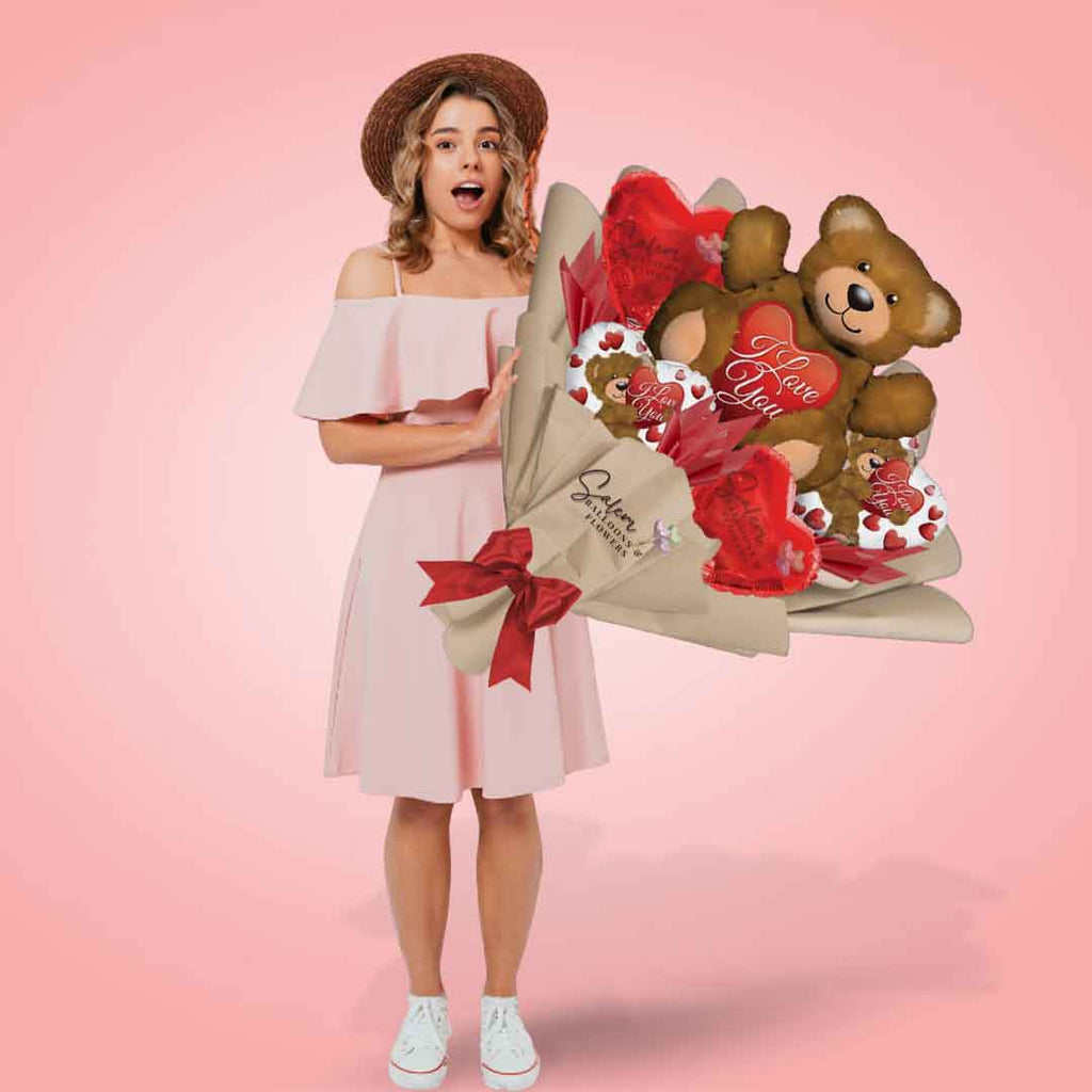 Wrapped balloon bouquet. Featuring a large teddy bear and heart balloons with an 