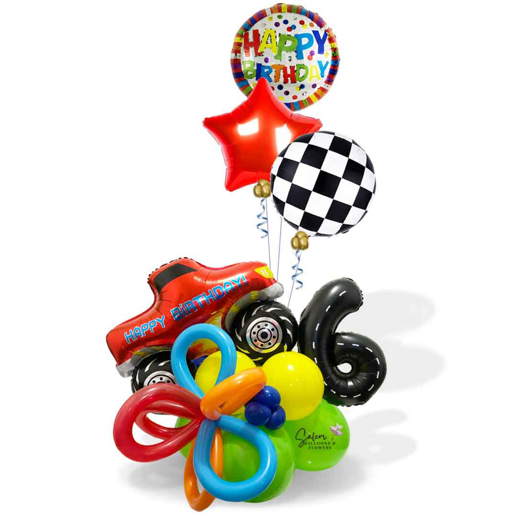 A red monster truck balloon with a happy birthday message climbing a colorful balloon base with number balloon decorated as a road and a set of 3 helium balloons. Balloon delivery in Salem Oregon and nearby cities.