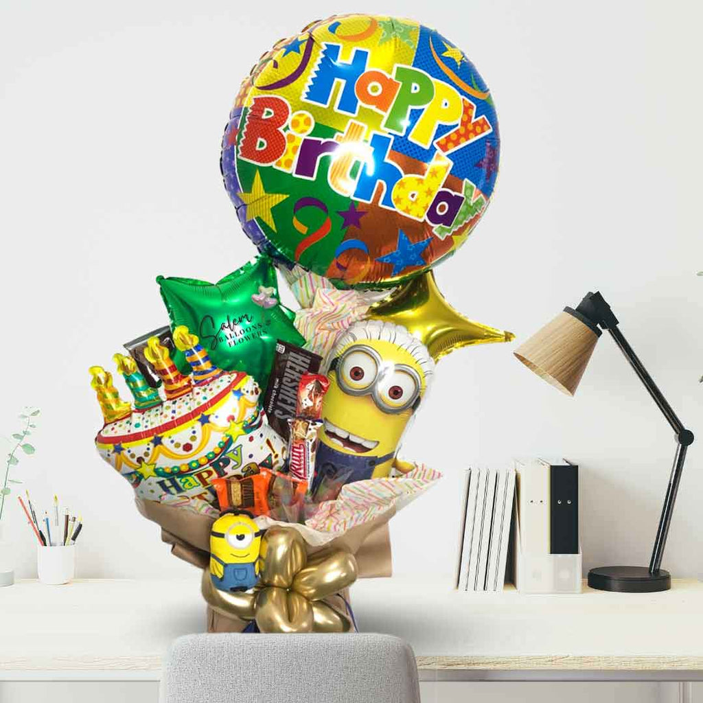 minion themed balloon bouquet with candy standing on a desk. Approx. 2 Ft tall. Salem Oregon and nearby cities. Balloon delivery