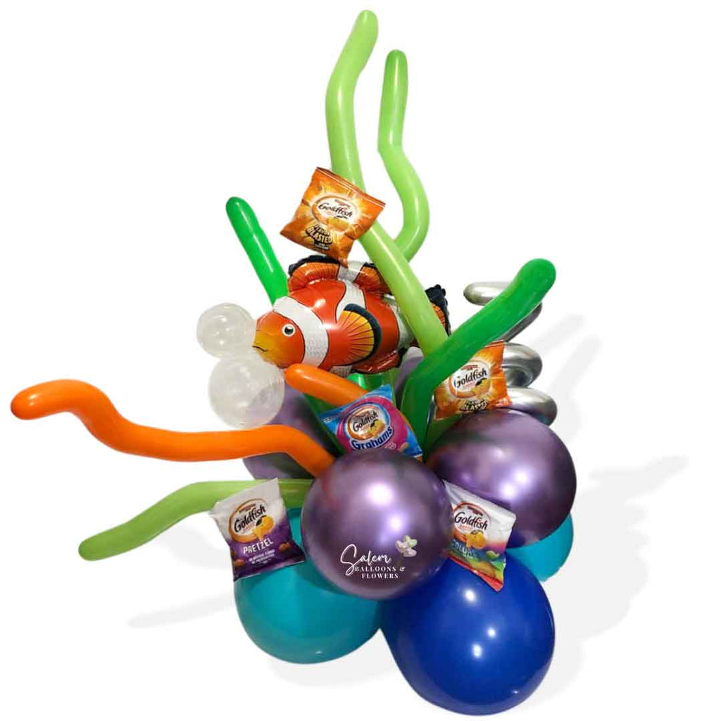 A Nemo themed balloon bouquet a Nemo balloon swimming in a balloon reef surrounded by goldfish snacks.  Salem Oregon balloon delivery. Balloon centerpiece of balloon decor