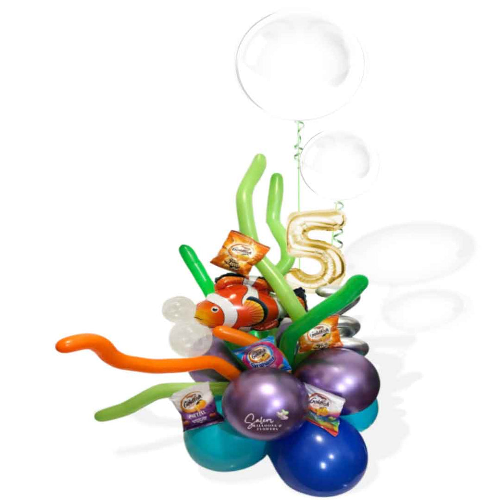 A Nemo themed balloon bouquet a Nemo balloon swimming in a balloon reef surrounded by goldfish snacks as  2 large bubble balloons float above it and decorated with a golden balloon number 5. Salem Oregon balloon delivery.