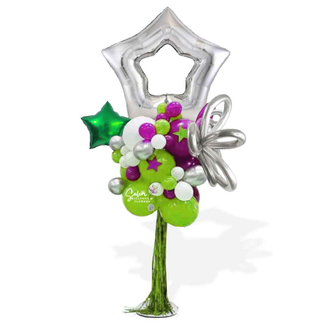 A Silver open Star Topper Balloon Column with tinsel bangs in various tones of green and magenta, decorated with curly balloons and stars. Oregon Balloon Decor.