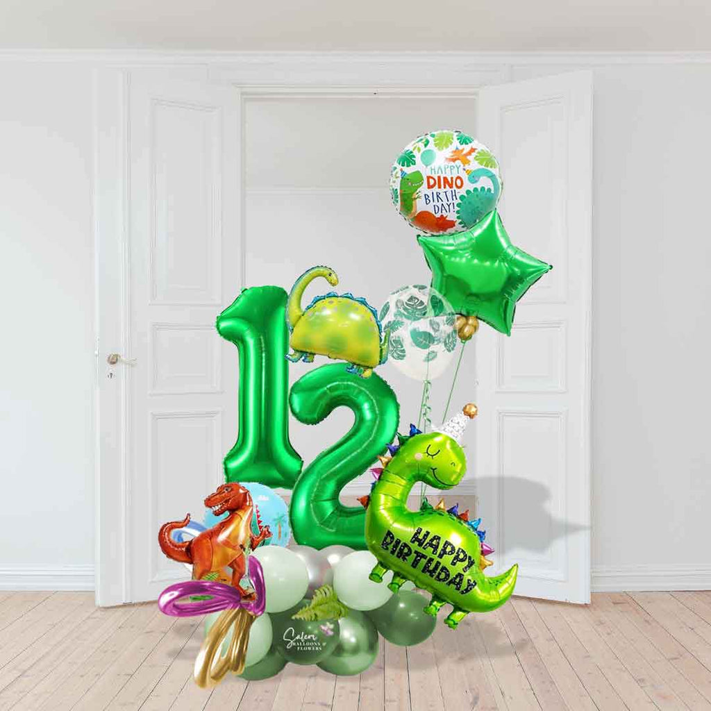 A name and a Dinosaur-themed number balloon marquee. Featuring Dinosaur shaped balloons, 2 large number balloons, and a helium balloon bouquet, standing in front of a door. Approx 7 ft Tall. Salem Oregon balloon decor. Balloons Salem Oregon