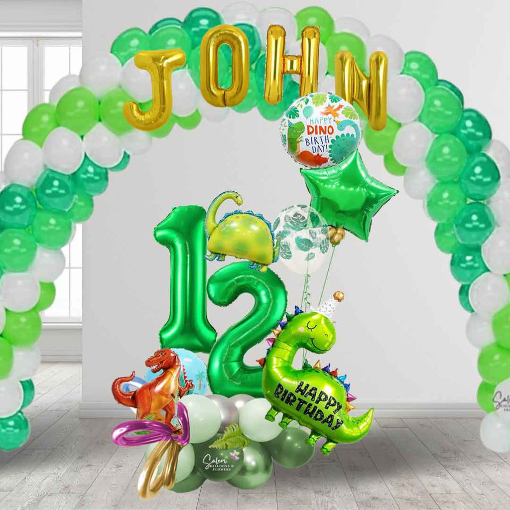 A large green balloon arch with a name and a Dinosaur-themed number balloon marquee. Featuring Dinosaur shaped balloons, 2 large number balloons, and a helium balloon bouquet. Salem Oregon balloon decor. Balloons Salem Oregon