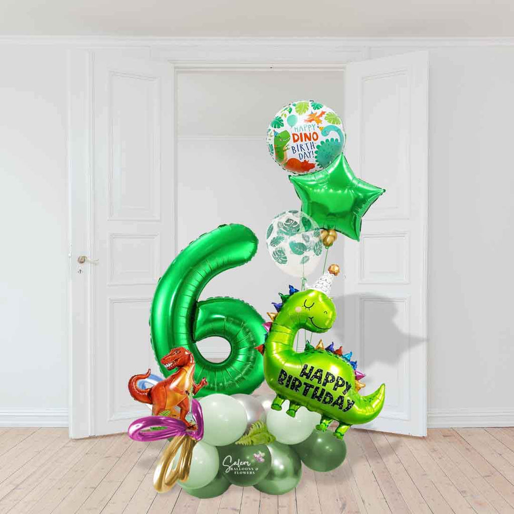 A name and a Dinosaur-themed number balloon marquee. Featuring Dinosaur shaped balloons, 1 large number balloon and a helium balloon bouquet, standing in front of a door. Approx 7 ft Tall. Salem Oregon balloon decor. Balloons Salem Oregon