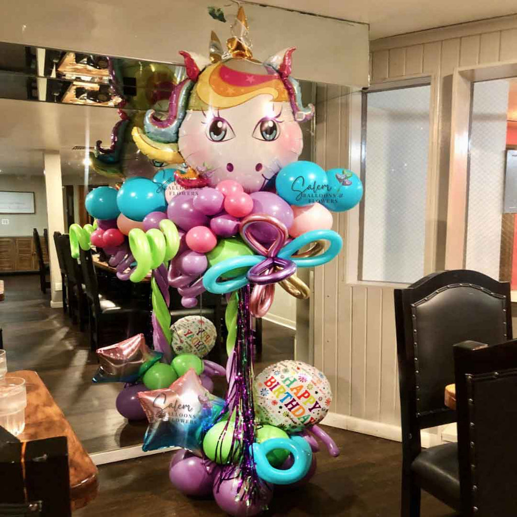 Unicorn themed Balloon Column. In vibrant pastel colors. Featuring a large Unicorn head as topper. Picture taken in 