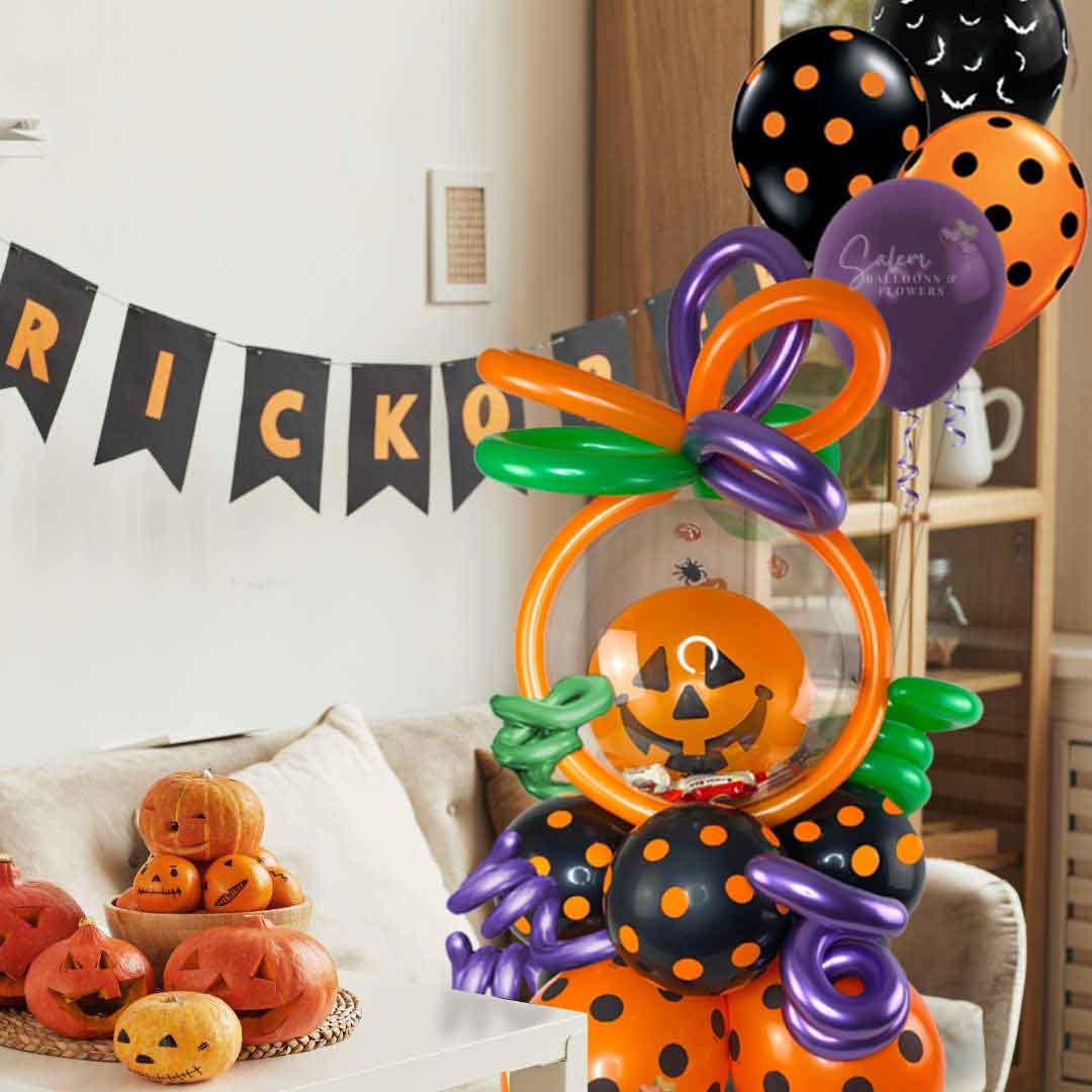 A Pumpkin head stuffed bubble balloon. Filled with halloween candy and decorated with helium balloons sitting on a couch in a halloween decorated Living room. Oregon balloon delivery.