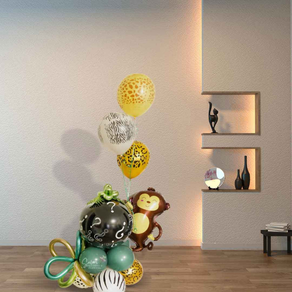 A balloon arrangement in a Living Room wall.   Monkey Balloon holding a black bubble balloon filled with pink or blue balloons and decorated with a safari themed. Gender reveal Balloon bouquet. Oregon Balloon deliverySafari-Gender-Reveal-Bubble-Balloon.Salem-Oregon-balloon-delivery