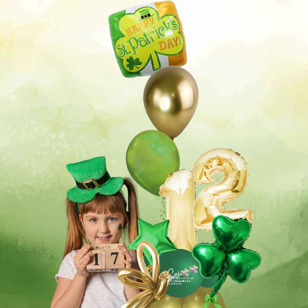 A little girl holding a St. Patrick's Day themed number balloon bouquet. Featuring a set of helium balloons with a 