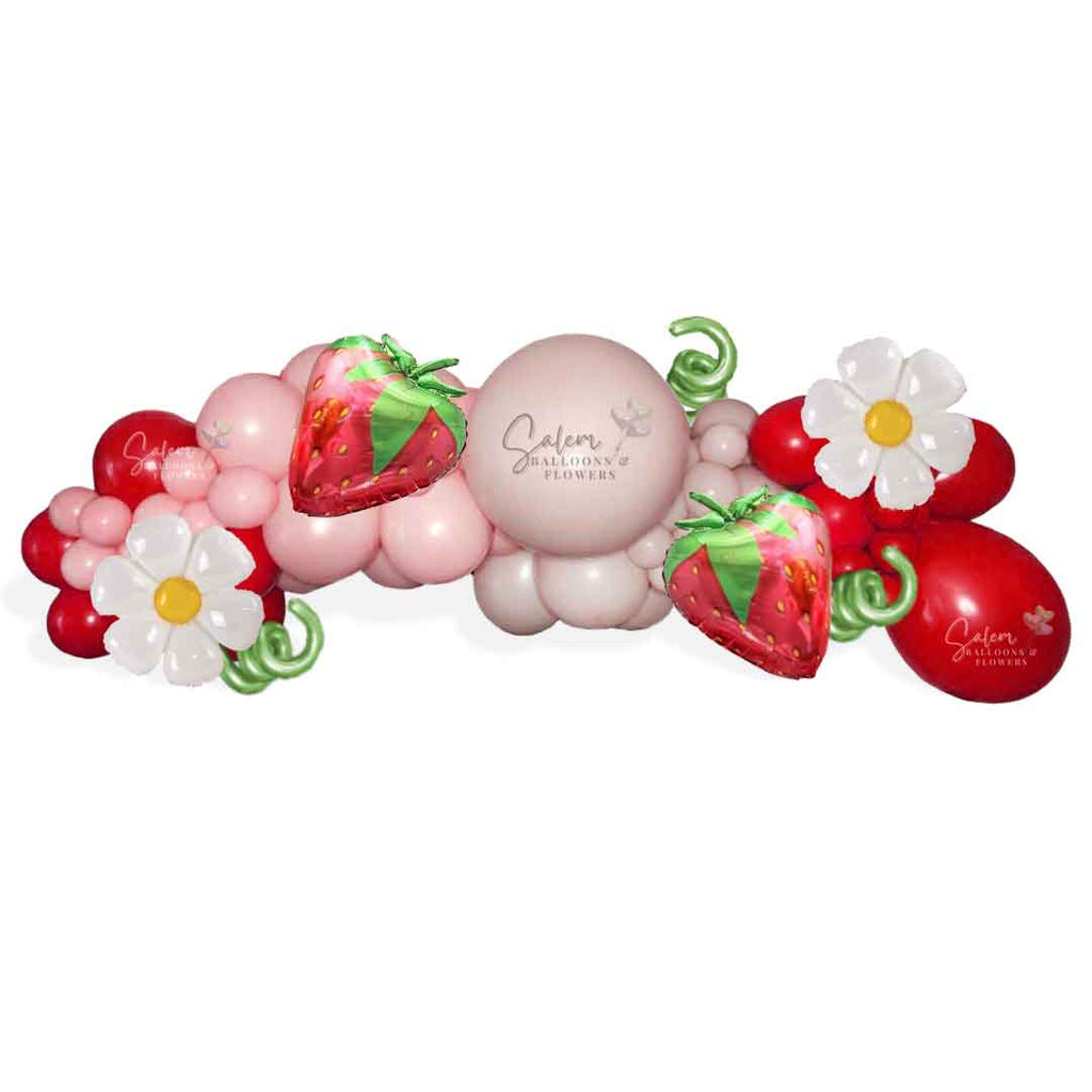 Strawberry Shortcake themed balloon decoration, featuring a balloon garland, in shades of in pinks, red and a touch of green. Balloon Decor. Oregon.