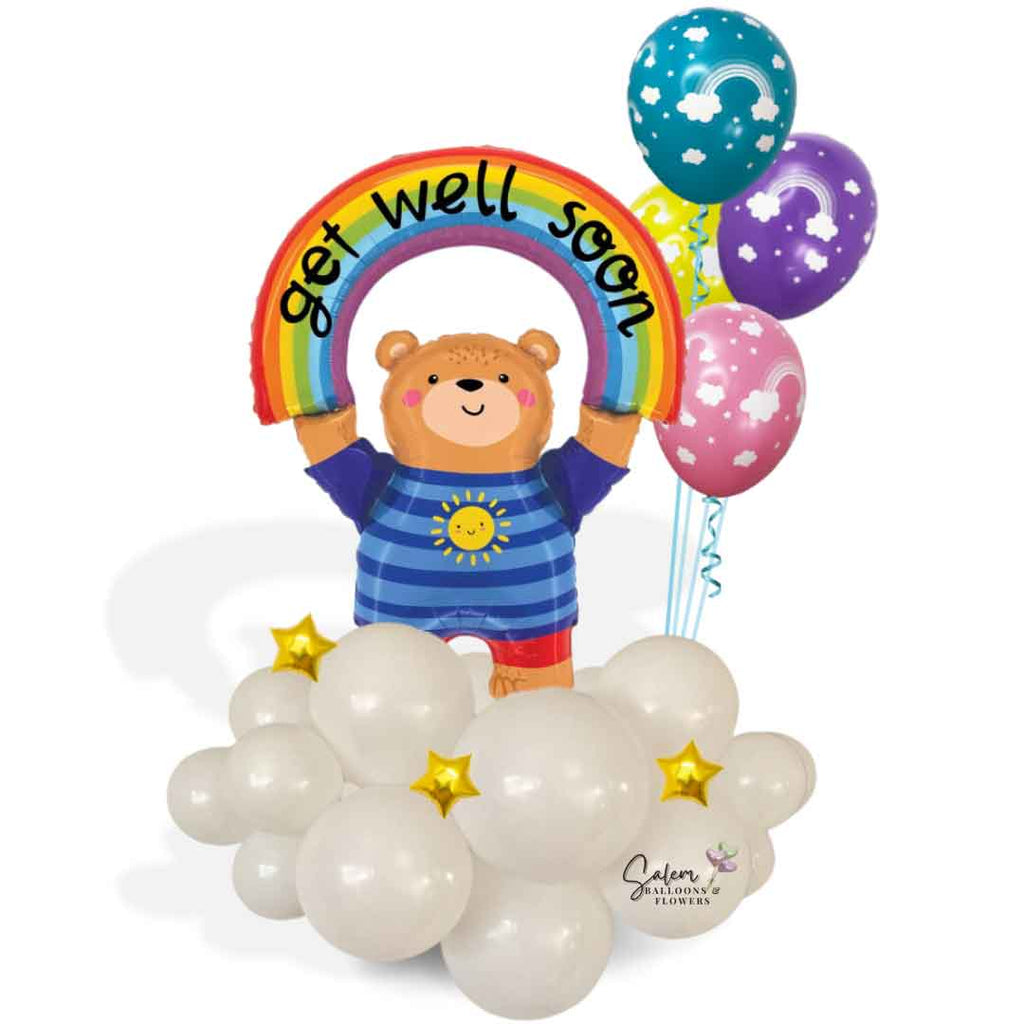 A charming teddy bear balloon holding a rainbow with a heartfelt 