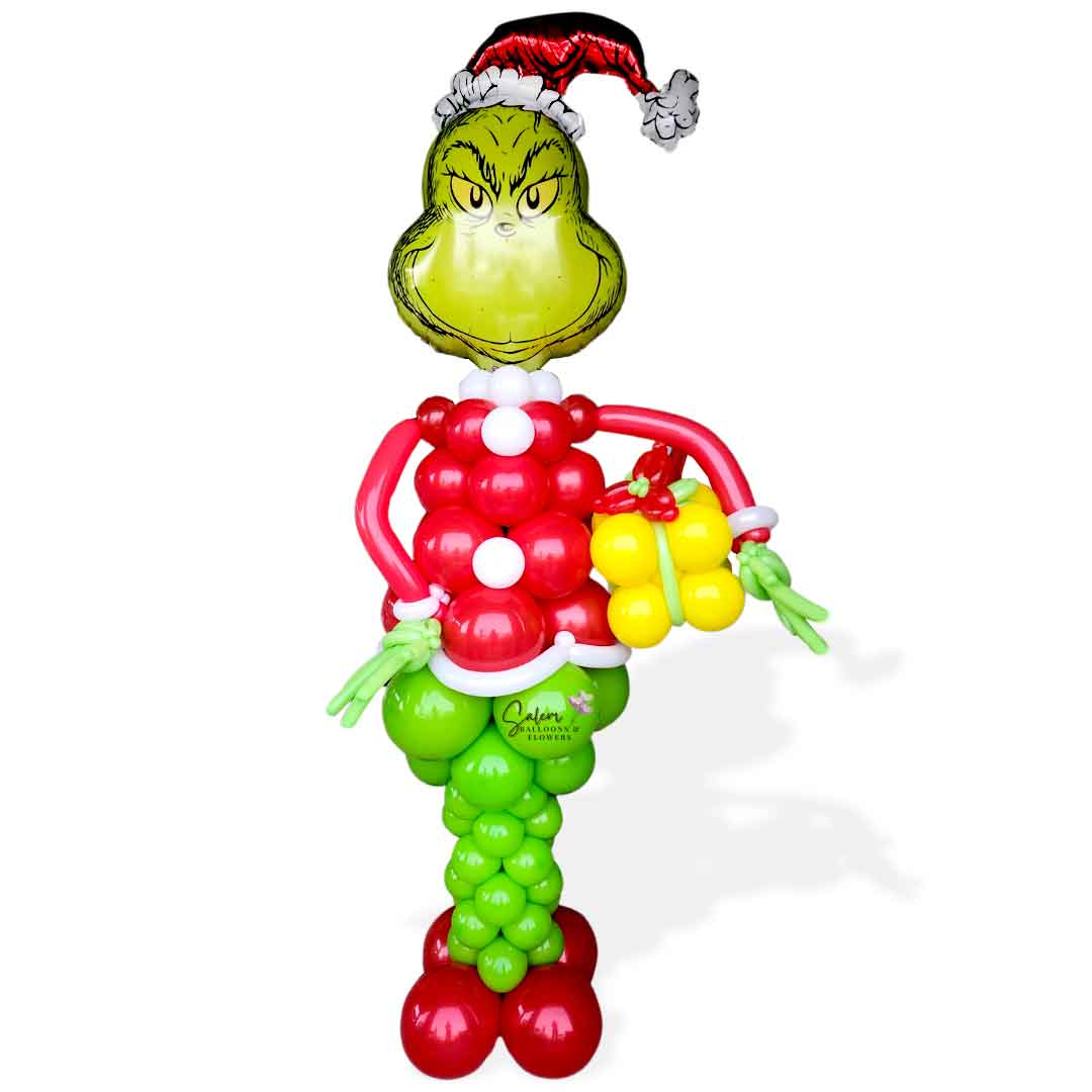 Mr. Grinch Balloon column. Shaped as Mr. Grinch holding a gift. In a Green and red color palette. Oregon Balloon Decor.