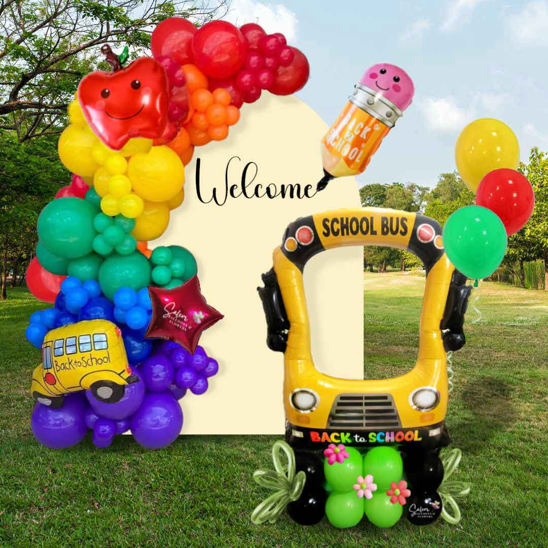 A one panel one garland Back to School Balloon decoration setted outdoors and decorated with an extra large school bus photo booth balloon. Oregon balloon decor.