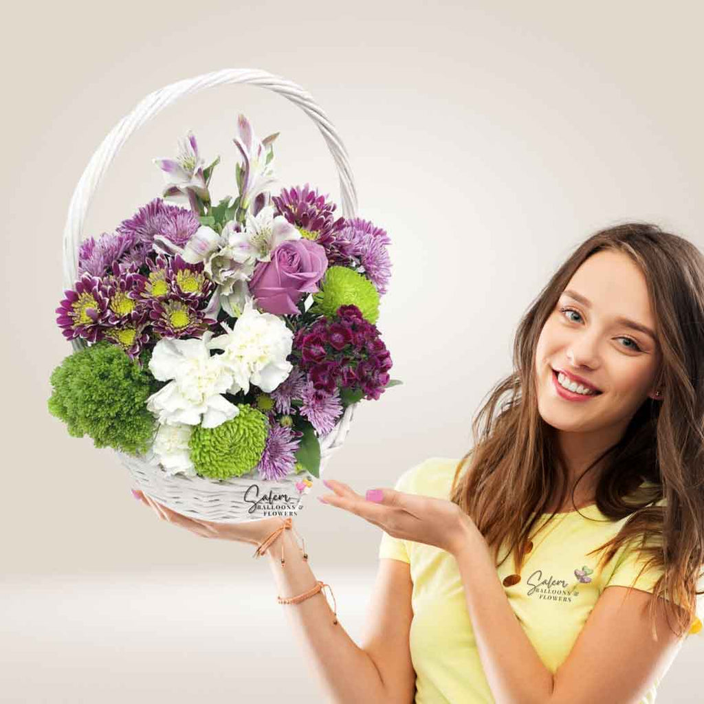 A young girl showing a white basket with fresh flowers. Flower delivery Salem Oregon 