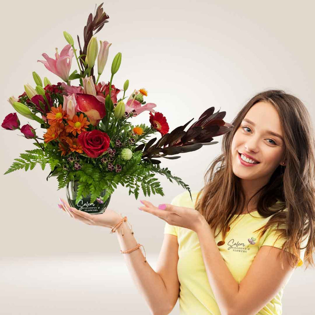 Flower arrangement with daisies, lilies, calas, gerberas, and roses in a glass vase. Flower delivery Salem Oregon. approx size.