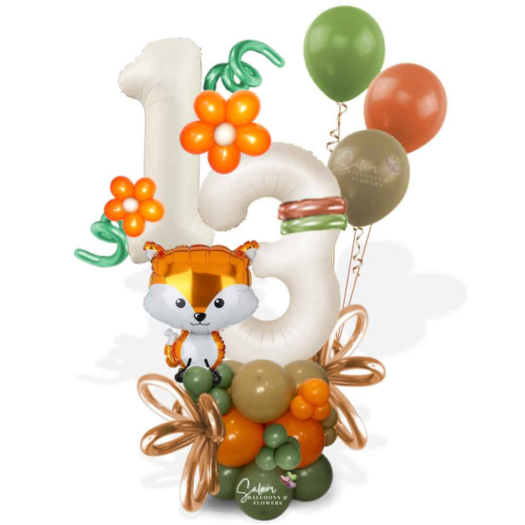 Woodland themed balloon bouquet with 2 large balloon numbers, in a green, orange and beige color palette. Featuring a cute Fox shaped balloon. Balloons Salem Oregon